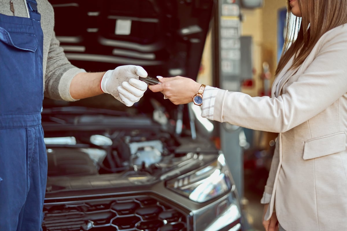 Mechanic handing car keys to customer